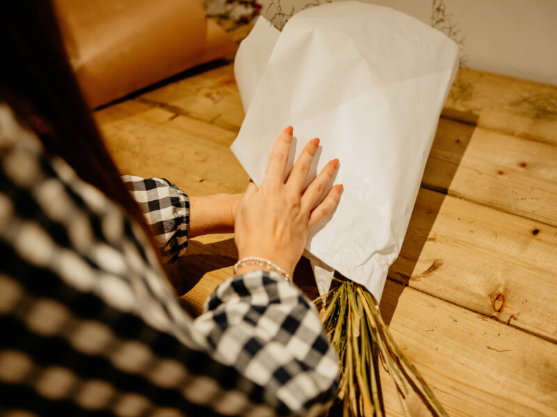 Hands wrapping a bouquet